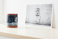 Banksy Mild Mild West ceramic mug in bright lifestyle setting alongside original Banksy artwork print