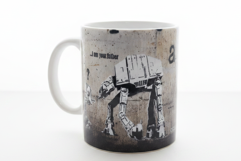 Banksy I Am Your Father AT-AT ceramic mug on clean white surface, bright lifestyle product photography