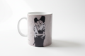 Banksy Kissing Police ceramic mug on clean white surface, bright lifestyle product photography